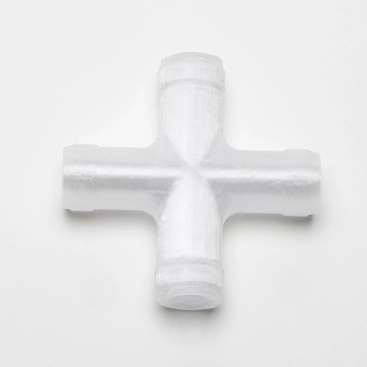 Close-up of the white 4-way cross Tubing Connector