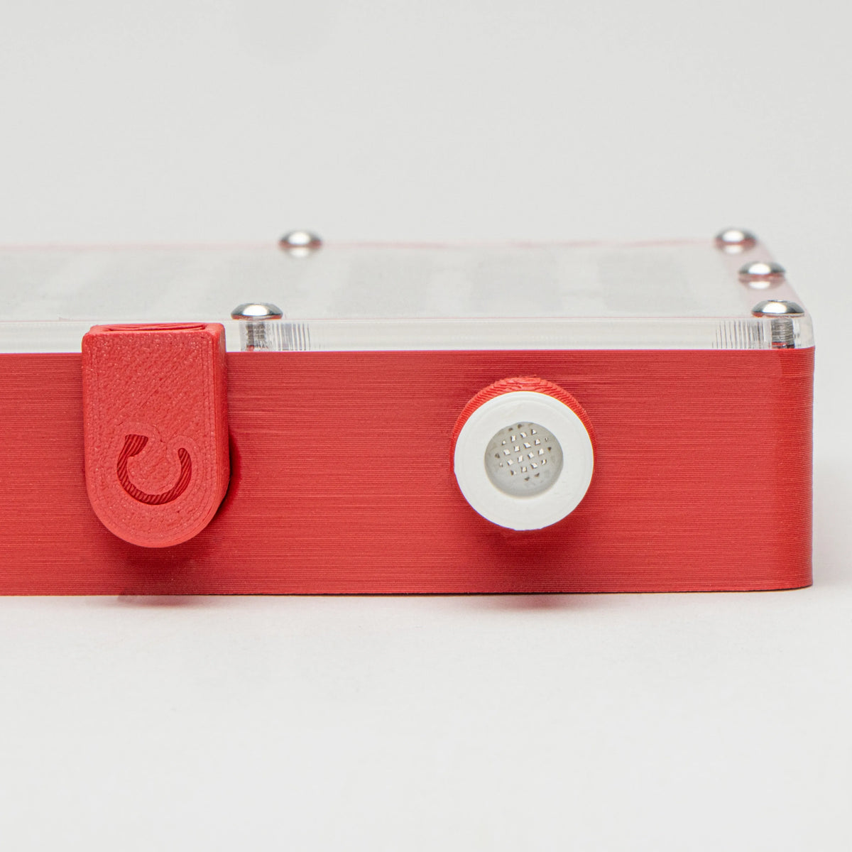 White Vented Stopper inserted into a ventilation port on a red 3D-printed ant enclosure
