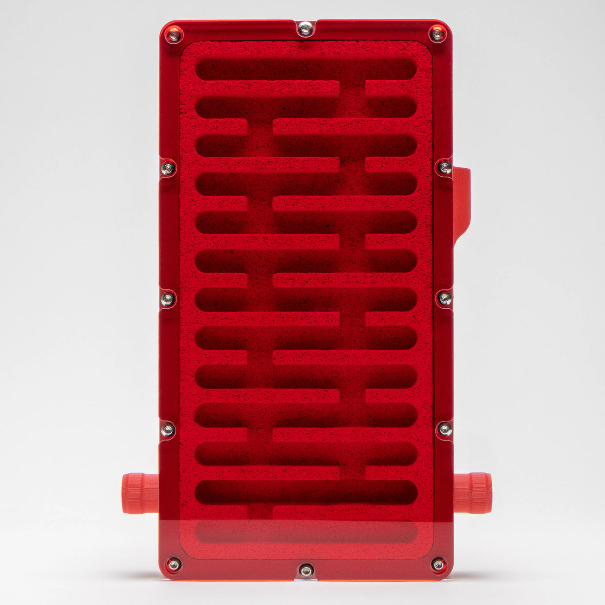 Large Ytong Nest - Type A photographed under red mood lighting, showing the thirteen-chamber Ytong stone layout